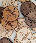 Front view of round wooden soap labels engraved with StoneRiver Soaps, each with a hanging hole.