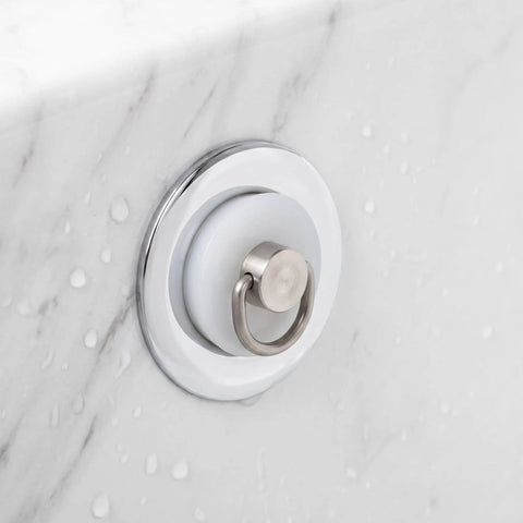 White Drain Stopper with Hanging Ring for Bathtub and Sink mounted on marble surface, showcasing its silicone design and metal ring.