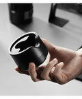 Heavy Duty Adjustable 51 53 58 Millimeter Portafilter Holder Tamping Platform Crafted From Tough Aluminum hand-held for espresso preparation.