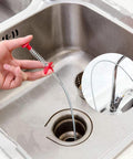 4-pack telescoping magnet pick-up tools with red grips used to retrieve metal from a kitchen sink drain (front view).