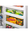 Hella Roomy White Upright Freezer With 16.7 Cubic Feet Of Storage showing organized shelves of frozen vegetables and fries.