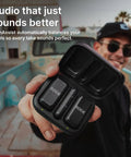 Person holding Two Mic Wireless Microphone System With Charging Case For Smartphones USB C No Cable Needed Quick Pairing