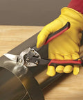 Left Cut Aviation Snips With Red Grips Power Fit Ergonomic Grips 18 Gauge Capacity cutting sheet metal on wooden table