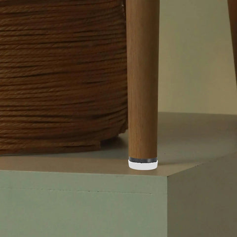 Anti Slip Furniture Pads With Nail On Glide for chair leg, rubber and steel, showing floor protection on hardwood surface.
