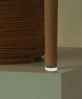 Close-up of chair leg with Anti Slip Furniture Glide Pads For Chairs And Tables With Nail On Design on a hardwood floor surface.