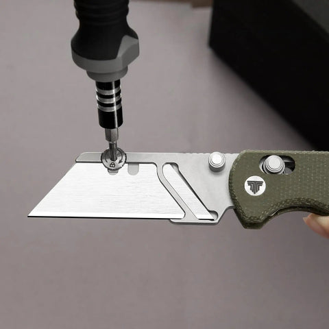 Folding Utility Knife With 2.62 Inch Razor Blade, showing blade replacement with screwdriver, green Micarta handle visible