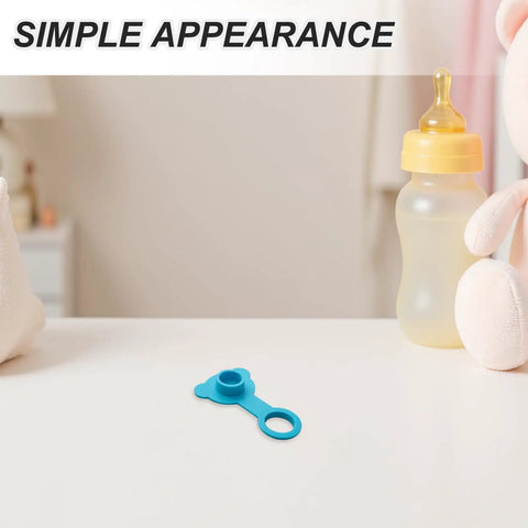 Blue Silicone Bathtub Plug Stopper for 1 Inch Drains on a table next to a baby bottle and plush toy.