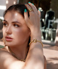 Woman wearing 14K Gold Filled Cable Wire Bracelet for Women, 7.8 Inch Classic Twist Rope with interlocking textured link chain.