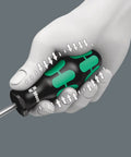 Hand holding Kraftform Plus Slotted Screwdriver with ergonomic multi-component handle and blade visible