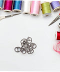 150 Pcs Miniature Alloy Buckles For Doll Clothes Shoes Belts Quick Release Metal Fasteners on sewing background