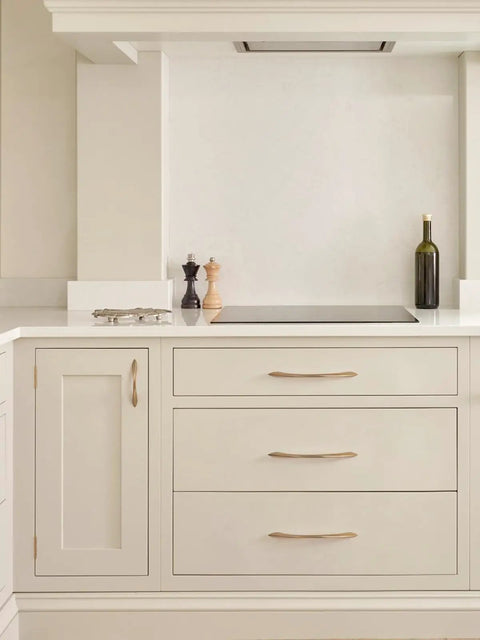 Champagne Bronze Cabinet Pulls 7.56 Inch Arch Twisted Brass Handles on cream kitchen cupboards and drawers