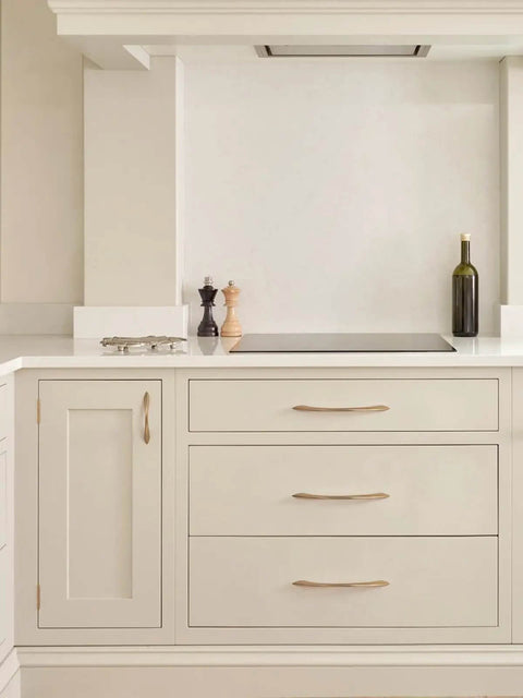 Champagne Bronze 3 Inch Arch Twisted Brass Cabinet Pulls 5 Pack installed on white kitchen drawers
