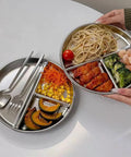 Hands holding Portion Control Plates For Grownups, Stainless Steel Divided Dinner Plates For Weight Loss And Diabetic Diets, Unbreakable 9 Inch Round Metal Dish for Kitchen, Camping And Picnic, with food in three sections.
