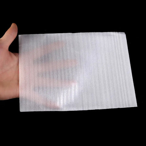 Hand holding single Foam Cushioning Pouches Pro Grade Pack Of 100 Full Coverage EPE Pearl Cotton Wrap for Fragile Items and Cups