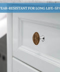 Installed Crystal Glass Round Cabinet Knob with Stainless Steel Base, Teak Wood Plank Texture, perfect for home decor.
