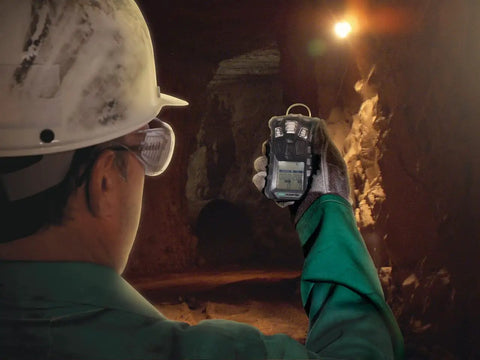 Worker using 4XR Multigas Detector Portable Handheld Gas Monitor With LEL O2 H2S CO Sensing in underground setting