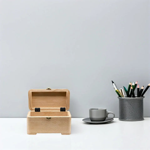 Black Iron Chest Hinges Set With Six Holes And Three Fold Straight Corner Design on wooden box next to cup and pencils