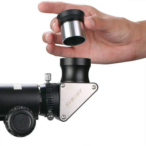 Hand holding lens over a Dielectric Star Diagonal 1.25 Inch 90 Degree, Fully Metal Construction, High Reflectivity For Sharp, Clear View