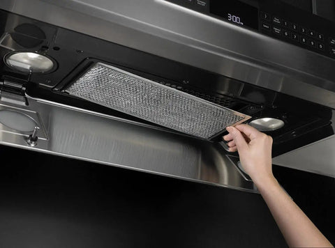 Genuine OEM Grease Filter for Range Hood Vent, Replaces 8190858, 1 Count, being installed under stainless steel hood.