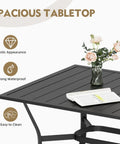Rectangular metal table from the 7 Piece Outdoor Dining Set with flower vase and newspaper, waterproof and easy to clean surface.
