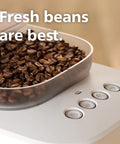 Bean To Cup Espresso Maker Featuring A Built In Grinder And Auto Milk Frother Delivering Thick Microfoam With A Rock Solid 16 Bar Pump showing fresh coffee beans in the grinder.