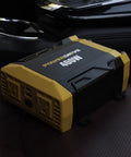 Rock Solid 400w Power Inverter Transforms 12v Dc To 110v Ac For Your Ride Featuring two three prong outlets on a car seat.