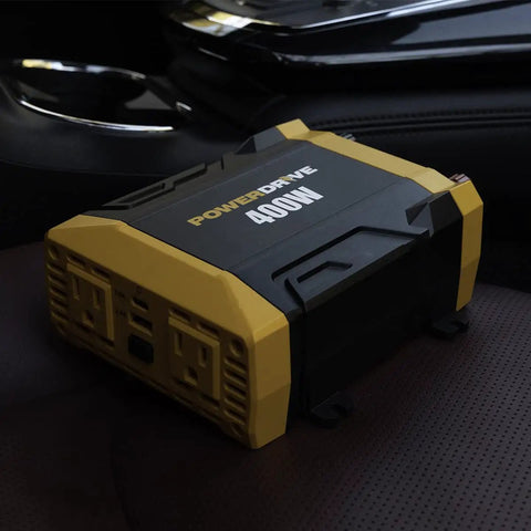 Rock Solid 400w Power Inverter Transforms 12v Dc To 110v Ac For Your Ride Featuring two three prong outlets on a car seat.