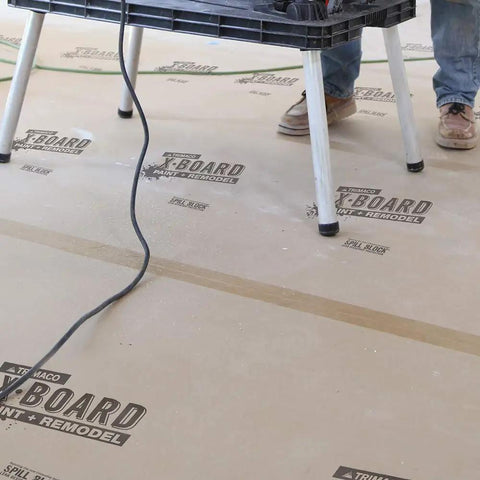 X Board Seam Tape Tan 1.89 Inch By 164 Foot Contractor Grade Adhesive applied on construction floor with work table