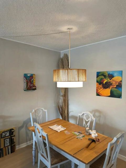 18 Inch Plug In Rattan Pendant Light With Premium Linen Shade Boho Ceiling Chandelier over dining table in rustic room setting.