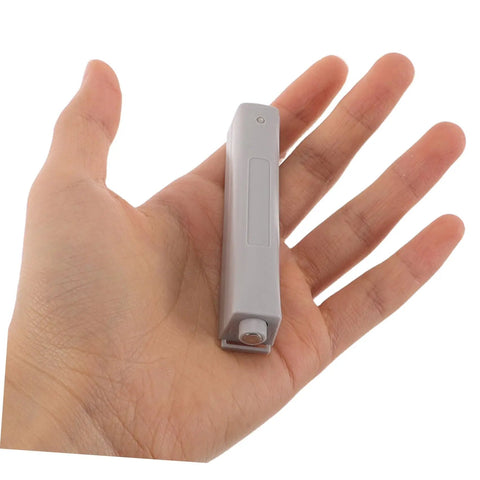 Four Pack No Brainer Push Latch Cabinet Door Catch Hidden Rebound Device shown in hand for scale