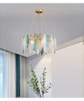 Next Level Modern Round Metal Glass Pendant Light With Six E14 Sockets Sleek Ceiling Hanging Lamp for Foyer or Dining Room with blue accents.