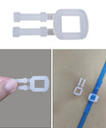 Plastic tension buckle from Tough As Nails Manual Banding Strapping Kit used for secure box sealing with blue tape.