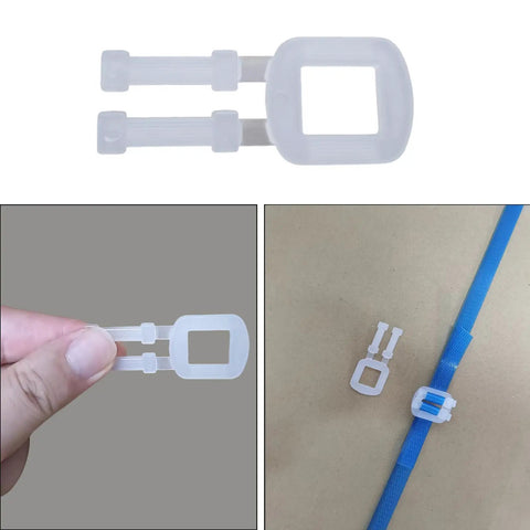 Plastic tension buckle from Tough As Nails Manual Banding Strapping Kit used for secure box sealing with blue tape.