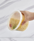 Hand holding 16-Ounce To-Go Food Storage Containers With Lids, BPA Free, Leakproof Microwave Safe, Stackable Grab-And-Go Meal Prep Boxes