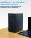 Rock Solid Eight Bay Thunderbolt 4 Usb4 Enclosure for two and three inch drives next to a laptop on a table.