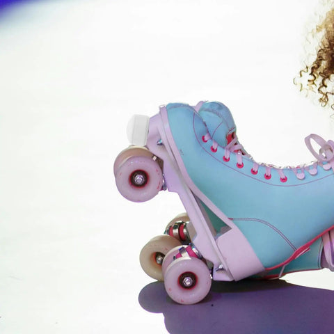 Roller Skate Toe Stoppers And Rubber Toe Guards with adjustable brake blocks on white quad skate for outdoor use.