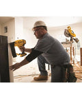 Worker using Battery Powered Cordless 18 Gauge Brad Nailer 20V Max XR with Brushless Motor for precise nail placement.