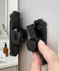 Sleek Black Barn Door Latch Made From Aluminum Alloy Supporting 90 And 180 Degree Swivel, shown on door with hand adjusting.