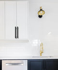Installed five inch black and gold knurled cabinet pulls set of ten heavy duty drawer handles on white kitchen cabinets.