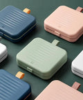 Assortment of colorful storage boxes including a Travel Size Sewing Kit With Compact Blue Storage Box, perfect for DIY use.