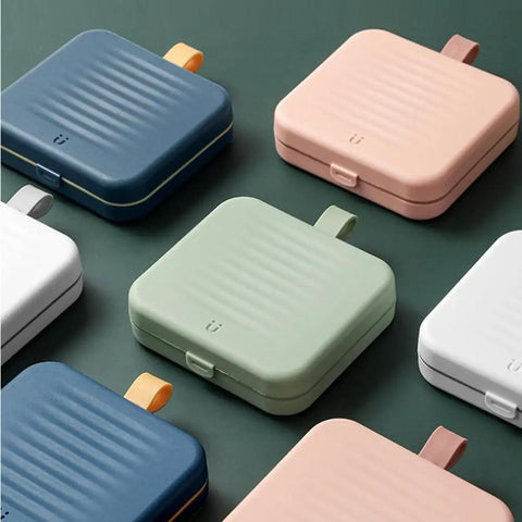 Assortment of colorful storage boxes including a Travel Size Sewing Kit With Compact Blue Storage Box, perfect for DIY use.