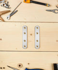 Flat Mending Plates 18 Pack Stainless Steel Brackets Easy Install No Sweat Heavy Duty Metal Joining Plates For Furniture And Home DIY Projects Shelves Cabinets And Repair Jobs displayed on a wooden surface with tools.