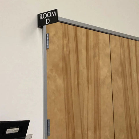 Heavy Duty Horizontal Warehouse Aisle Signs Custom Engraved L Shaped Rack Markers With Kickass Durable ABS Plastic Build Pre Drilled Mounting Holes Ready To Hang Made In Usa on wooden door.