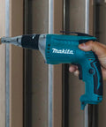 Person using FS2200 2500 RPM Drywall Screwdriver With Lightweight 3.5 lb Design on metal studs, ergonomic grip visible.