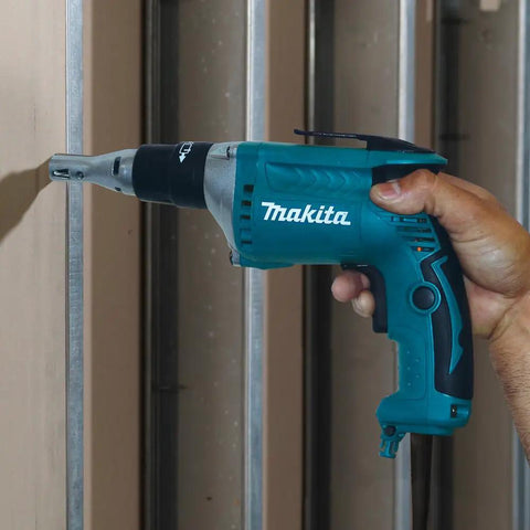 Person using FS2200 2500 RPM Drywall Screwdriver With Lightweight 3.5 lb Design on metal studs, ergonomic grip visible.