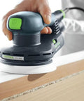 Heavy Duty 5 Inch Random Orbit Sander Featuring A Brushless Motor And Ergonomic Grip in use on wood edge.