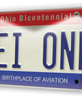 Ohio license plate reading 'DEI ONE' with bicentennial design and aviation birthplace text