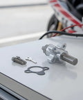 Top Shelf Aluminum Cam Chain Tensioner With Manual Tune Up For CBR600RR 2003 2018, bolts & seals on a workshop table.