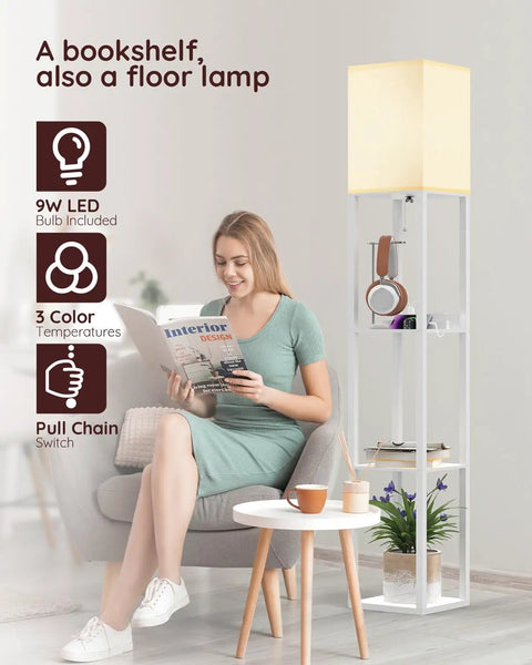 Woman reading next to Solid Wood Shelf Floor Lamp With 2 Charging Ports And 1 Power Outlet, white finish, beech shelves.