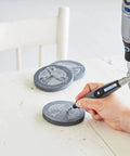 User carving a design on a slate disc with Top Tier Variable Speed Rotary Tool Kit With Hella Steady Flex Shaft And Badass Accessory Bundle.